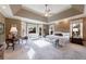 Spacious main bedroom featuring tray ceilings, natural light, and room for seating at 400 Laurel Chase Ct, Atlanta, GA 30327