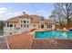 Backyard pool and deck with the home in the background and cloudy skies above at 400 Laurel Chase Ct, Atlanta, GA 30327