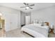 Neutral bedroom with large windows, ceiling fan, and walk in closet. Minimalist bedding at 1035 Hembree Grove Dr, Roswell, GA 30076