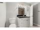 Bathroom featuring tiled shower, black granite counter, and a modern vanity at 265 Winding River Dr # F, Atlanta, GA 30350