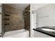 Well-lit bathroom with tile surround and tub at 265 Winding River Dr # F, Atlanta, GA 30350