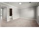 Spacious bedroom with neutral carpet and paint, featuring an ensuite bathroom and natural light at 265 Winding River Dr # F, Atlanta, GA 30350