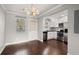 Inviting dining room features modern lighting and opens to a bright kitchen with stainless steel appliances at 265 Winding River Dr # F, Atlanta, GA 30350