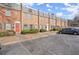 Brick townhome with grey roof, black shutters, and landscaped front; parking available in front at 265 Winding River Dr # F, Atlanta, GA 30350