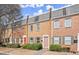 Exterior view of brick townhomes with well-maintained lawns and inviting curb appeal at 265 Winding River Dr # F, Atlanta, GA 30350