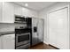 Stylish kitchen featuring stainless steel appliances, white cabinetry, and sleek countertops, ideal for meal preparation at 265 Winding River Dr # F, Atlanta, GA 30350