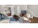 Cozy living room with hardwood floors, modern decor, a white staircase, and lots of natural light at 265 Winding River Dr # F, Atlanta, GA 30350
