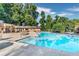 Community pool offers a refreshing spot with clear, blue water and lounging areas surrounded by lush greenery at 265 Winding River Dr # F, Atlanta, GA 30350