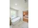 Bathroom featuring stand alone soaking tub, marble floors, and adjacent view to the main bedroom at 7602 Auden Trl, Atlanta, GA 30350