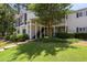 Two-story condo with covered front entry, black wrought-iron staircase and lush landscaping at 13 Little Silver Se Ct, Smyrna, GA 30080