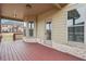 Back porch with wooden floor, tan siding, and white painted brick at 15 Streamside Dr, Covington, GA 30016