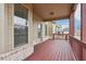 Cozy back porch with brown painted railings and wood flooring at 15 Streamside Dr, Covington, GA 30016