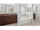 Bright bathroom features tiled floors, granite counter and soaking tub at 15 Streamside Dr, Covington, GA 30016