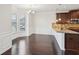 Bright dining area with dark wood floors, decorative molding, and plenty of natural light at 15 Streamside Dr, Covington, GA 30016