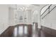 Formal dining room features dark hardwood floors, wainscoting, and tray ceiling at 15 Streamside Dr, Covington, GA 30016