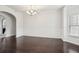 Elegant dining room featuring wainscoting, hardwood floors, and modern chandelier at 15 Streamside Dr, Covington, GA 30016