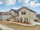 Charming two-story home with light siding, dark shutters, and attached garage at 15 Streamside Dr, Covington, GA 30016