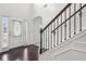 Elegant foyer with hardwood floors, staircase, and natural light from sidelight windows at 15 Streamside Dr, Covington, GA 30016