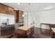 Open kitchen featuring stainless steel appliances, wooden cabinets, granite countertops, and hardwood floors at 15 Streamside Dr, Covington, GA 30016