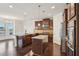 Well-lit kitchen with stainless steel appliances, granite countertops, and view of the breakfast area at 15 Streamside Dr, Covington, GA 30016