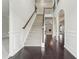 Spacious staircase with carpeted treads and dark wood floors at the landing at 15 Streamside Dr, Covington, GA 30016