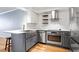 A well-lit kitchen featuring subway tile backsplash, open shelving, a farmhouse sink and modern stainless steel appliances at 2870 Pharr Nw Ct # 2008, Atlanta, GA 30305