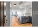 This shot displays a stylish kitchen with modern farmhouse sink, stainless steel appliances and an open doorway to the living area at 2870 Pharr Nw Ct # 2008, Atlanta, GA 30305