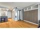 View of a well-lit living room space with hardwood floors and featuring a murphy bed tucked into custom shelving at 2870 Pharr Nw Ct # 2008, Atlanta, GA 30305