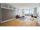 Bright living room featuring a murphy bed, hardwood floors, and floor-to-ceiling windows offering scenic views at 2870 Pharr Nw Ct # 2008, Atlanta, GA 30305