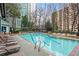 Outdoor swimming pool area with lounge chairs and lush surroundings, perfect for relaxation and recreation at 2870 Pharr Nw Ct # 2008, Atlanta, GA 30305