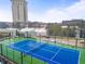 Rooftop tennis court for residents, with blue surface and green surround at 2870 Pharr Nw Ct # 2008, Atlanta, GA 30305