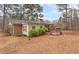 Backyard with a brick home and a deck surrounded by a wooded area at 4648 Seward Rd, Powder Springs, GA 30127