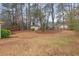 Spacious wooded backyard featuring a storage shed at 4648 Seward Rd, Powder Springs, GA 30127