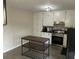 Bright kitchen featuring white cabinets, black countertops, and stainless steel appliances at 120 Mossy Brook Dr, Stockbridge, GA 30281