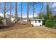 Fenced backyard features a charming shed, swing and mature trees providing shade at 1558 Grant Ne Dr, Atlanta, GA 30319