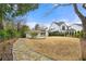 The large, grassy backyard features a stone walkway and well-manicured landscaping at 1558 Grant Ne Dr, Atlanta, GA 30319