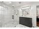 Bathroom features a frameless shower, marble floors and gray vanity with gold hardware at 1558 Grant Ne Dr, Atlanta, GA 30319