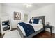 Cozy bedroom with a queen-sized bed, dark hardwood floors, and white walls at 1558 Grant Ne Dr, Atlanta, GA 30319