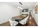 Elegant dining room featuring a modern light fixture, a large table, and hardwood floors at 1558 Grant Ne Dr, Atlanta, GA 30319