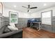 Home office with dark wood floors, gray wainscoting, and a comfortable seating area at 1558 Grant Ne Dr, Atlanta, GA 30319