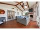 The sunroom has a brick fireplace, mounted TV and wooden beams on the vaulted ceiling at 1558 Grant Ne Dr, Atlanta, GA 30319