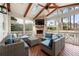 Relaxing sunroom with brick fireplace, ceiling fan, skylight and comfortable seating at 1558 Grant Ne Dr, Atlanta, GA 30319