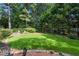 Sprawling backyard featuring lush lawn, mature trees, and a cozy fire pit at 2231 Fairoaks Rd, Decatur, GA 30033