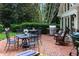 Brick patio offering an outdoor dining area with mature trees and landscaping at 2231 Fairoaks Rd, Decatur, GA 30033