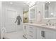 Bright bathroom with dual sinks, modern fixtures, white cabinets, and a soaking tub at 2231 Fairoaks Rd, Decatur, GA 30033