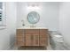 Bathroom featuring a vanity with a quartz counter, a round mirror, and tile flooring at 2231 Fairoaks Rd, Decatur, GA 30033