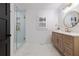 Modern bathroom featuring a glass shower, quartz counter, and brushed gold fixtures at 2231 Fairoaks Rd, Decatur, GA 30033