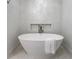 Sleek bathroom with a modern soaking tub and white towel at 2231 Fairoaks Rd, Decatur, GA 30033