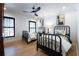 Bright bedroom featuring two beds, light hardwood flooring, and a contemporary ceiling fan at 2231 Fairoaks Rd, Decatur, GA 30033