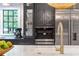 Gourmet kitchen with stainless appliances, custom cabinetry, and center island with white marble countertops at 2231 Fairoaks Rd, Decatur, GA 30033